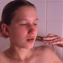 Cute teen relieves herself in bathroom